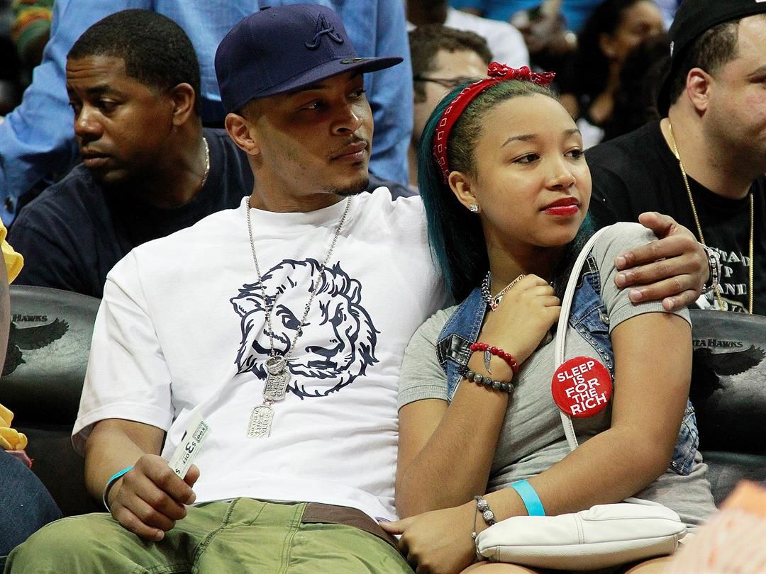 Recording artist and actor T.I. sits with his step daughter Zonnique Pullins, of OMG Girlz, during Game 2 of an NBA first-round playoff series basketball game Tuesday, May 1, 2012, in Atlanta. (AP Photo/John Bazemore)